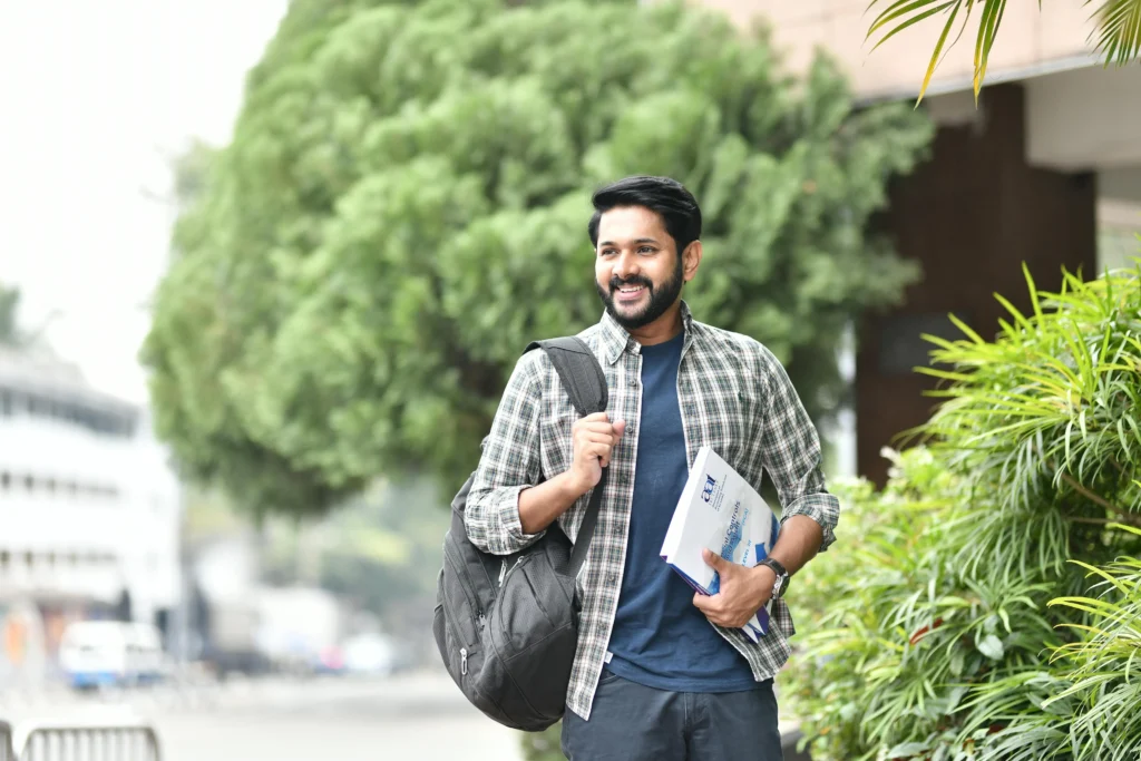Student holding brochure using college branding.