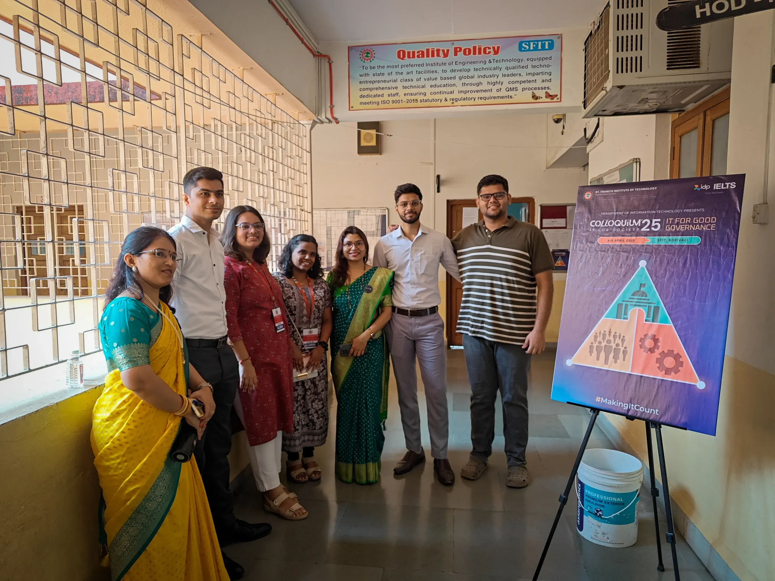 Judges posing with Colloquium 2025 poster.